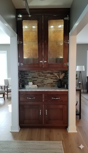 Dark wood built-in cabinet with glass doors and granite countertop